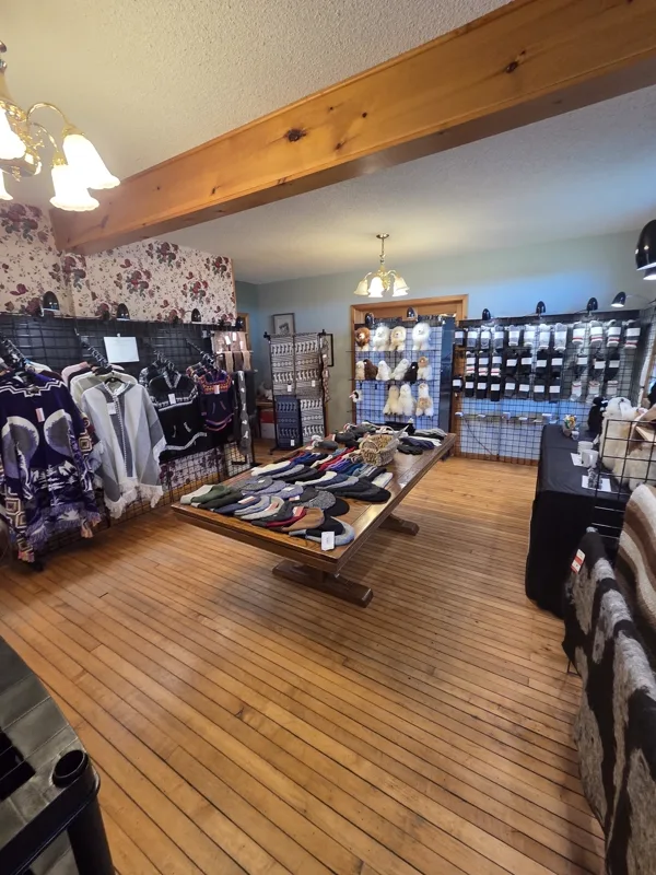 The Laslyn Alpaca shop in the farm house, with garments, hats and a display table